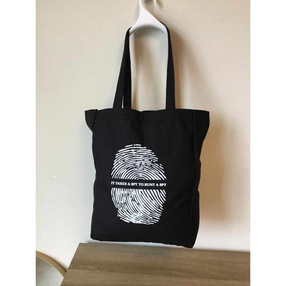 Black Canvas Tote with White Fingerprint Graphic "IT TAKES A SPY TO HUNT A SPY"
